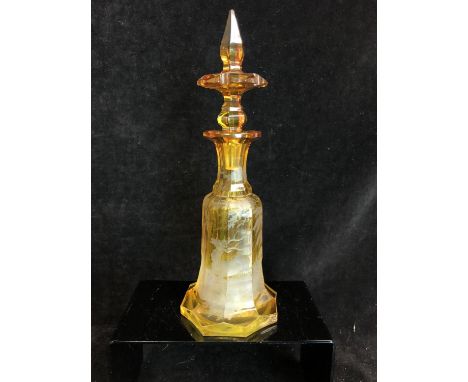 Bohemian Glass - An amber cut through to clear glass perfume bottle and stopper, the panelled bell form body cut with a stag 