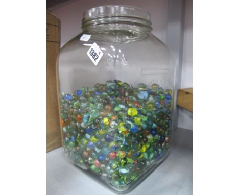 A Very Large Number of XX Century Marbles, (many hundreds) in a vintage glass butter churn jar.
