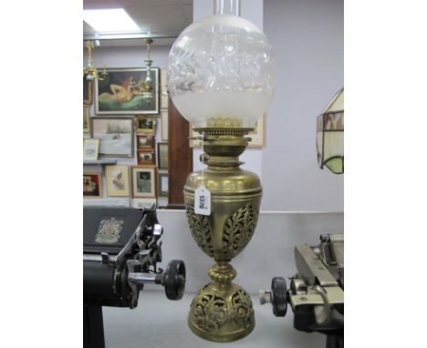 A Belgian Brass Oil Lamp, with scroll and leaf pierced base with glass shade (cracked) plus funnel.