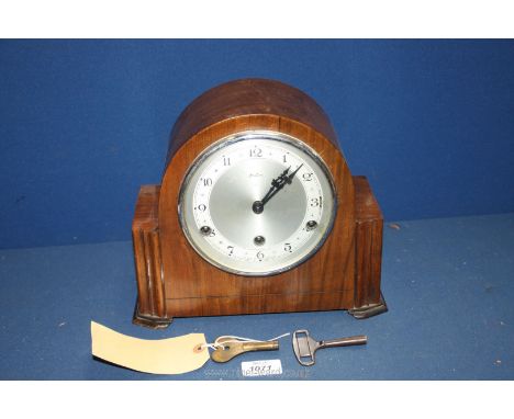 A Bentima mantle Clock with Arabic numerals, with key and pendulum, 10 1/2'' wide x 5'' deep x 9'' tall.