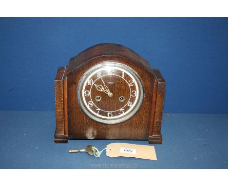 An Enfield mantle clock with Arabic numerals, with key and pendulum, 11'' wide x 4 1/2'' deep x 9 1/4'' tall.