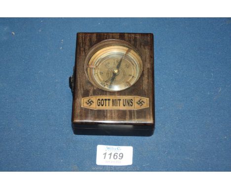 A cased military type Compass having bevelled glass, the loop stamped 1942, marked to the underside ''National Sozialistiche 