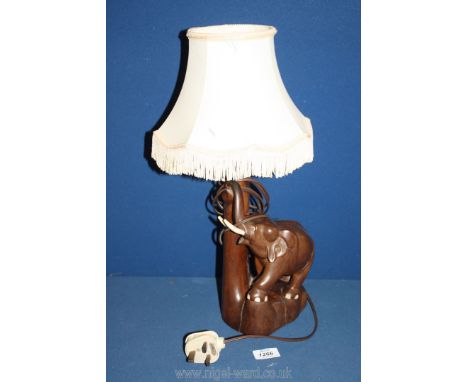 A table lamp in the form of an Elephant, 13'' tall, 18'' with shade.