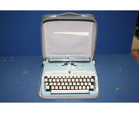 A Brother Deluxe Typewriter in carrying case, 12'' x 12''.