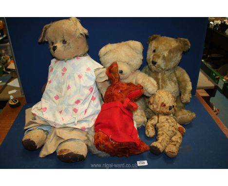 Five old soft toys including a jointed Teddy with one glass eye, one with a bell in the ear, vintage Basil Brush, Wendy Bosto