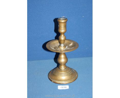 A large Dutch brass 'heemskirk' candlestick, early to mid 17th century, with central drip pan and extraction hole to socket, 
