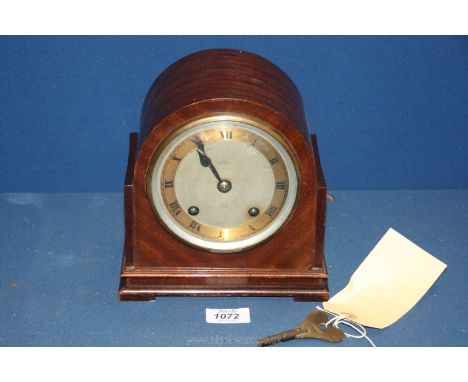 A Dent mantle clock with Roman numerals, with key, 7 1/2'' wide x 4 3/4'' deep x 7 1/2'' tall.