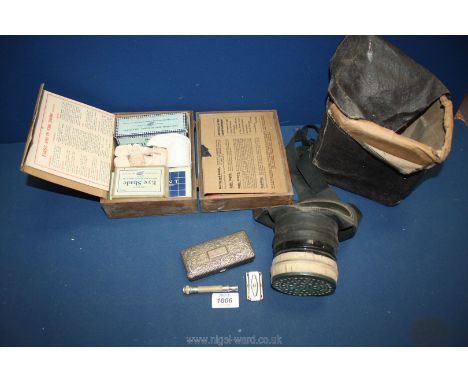 A box of assortments to include a Boots Home First Aid Kit, Gas mask in original box and a razor in white metal tin.