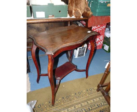 An early 20th c. Mahogany occasional Table having a shaped top and canted legs united by a lower shelf stretcher, 24'' x 14 5