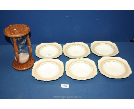 A sand egg timer together with six Crown Ducal dishes.