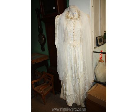 An ivory silk wedding Dress by Sally Stade of Regent Street, size M, with pearl buttons and long sleeves, with pearl effect h