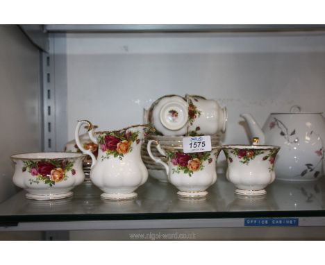 A Royal Albert 'Country Roses' part Teaset including six cups, nine saucers, milk jug, etc.