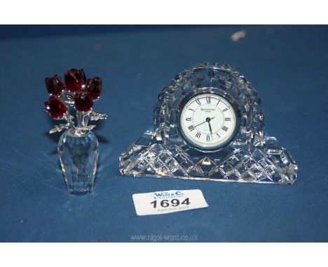 A boxed Waterford quartz miniature mantle clock and a boxed Swarovski crystal rose bouquet.