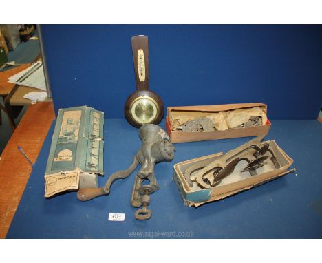 A vintage food mincer, small Scholz German barometer and quantity of boxed ice skate blades.
