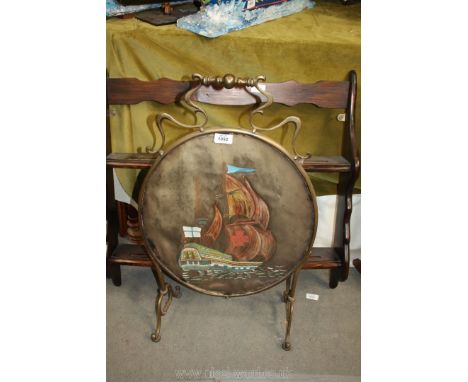 A brass framed firescreen with oval panel, centre having a picture of a galleon.