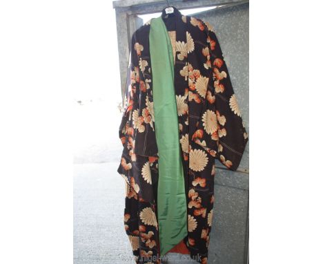 Two vintage Kimonos including black, orange and white floral (moth damage) and a black with sash, both a/f.
