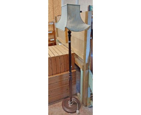 A 20th Century stained oak standard lamp and shade