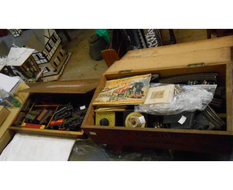 A vintage Meccano box containing a quantity of Trix Twin railway items including engine and tender, wagons and other model ra