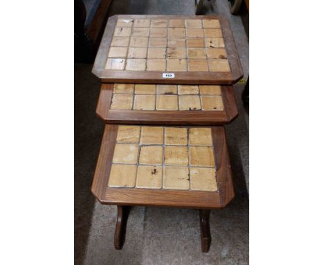 A nest of three retro Nathan teak and mixed wood tile top tea tables - for re-polishing