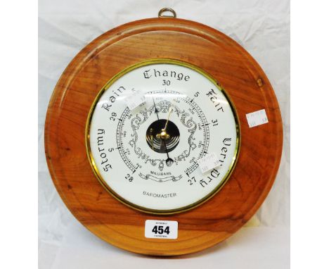 A modern Baromaster polished wood cased wall barometer with visible aneroid works to dial centre