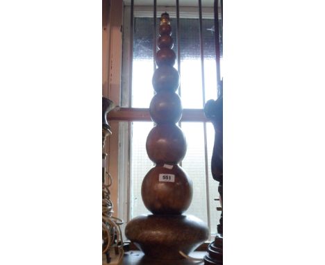 A large turned wood lamp
