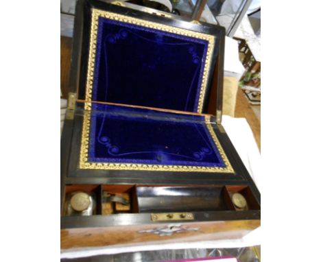 A Victorian burr walnut veneered and mother-of-pearl inlaid writing slope with fitted interior containing pair of inkwells, p