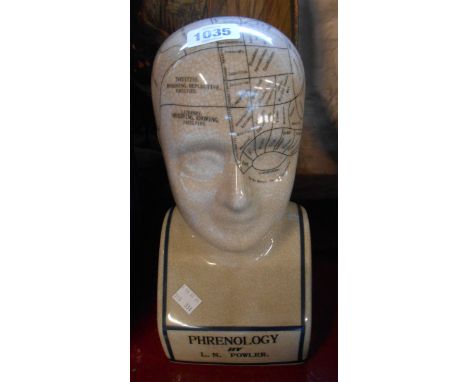 A modern ceramic phrenology head with crackle effect glaze