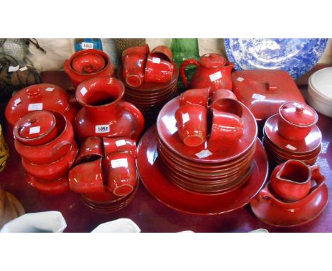 A quantity of vintage Italian Ernestine red glazed kitchen ceramics comprising soup tureen and ladle, six soup bowls, large j