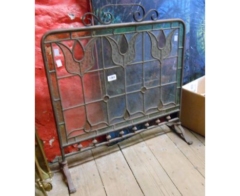 An Art Nouveau metal framed and stained glass fire screen
