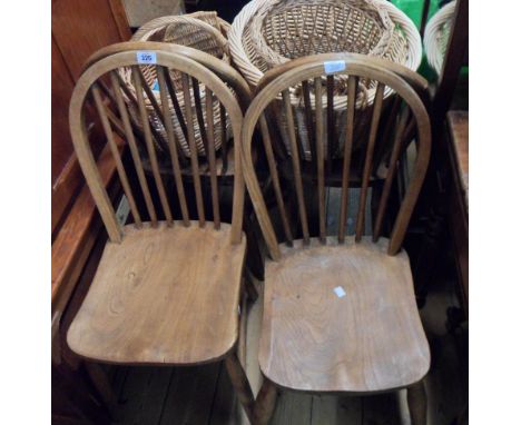 A set of four antique mixed wood hoop stick back kitchen chairs with solid moudled elm seats, set on tapered supports - stamp