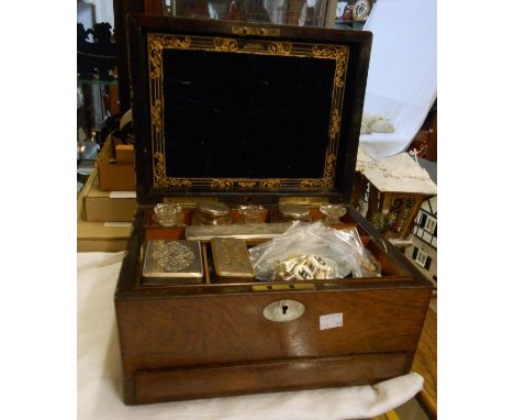 A 19th Century rosewood veneered vanity box with mother-of-pearl inlay containing assorted bottles, jars and trinket boxes wi