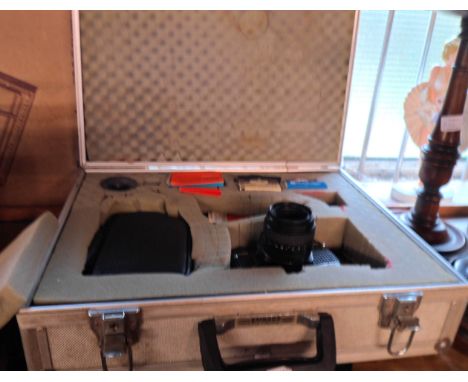 A Praktica B200 camera with Pentacon 50mm lens and other accessories in aluminium flight case