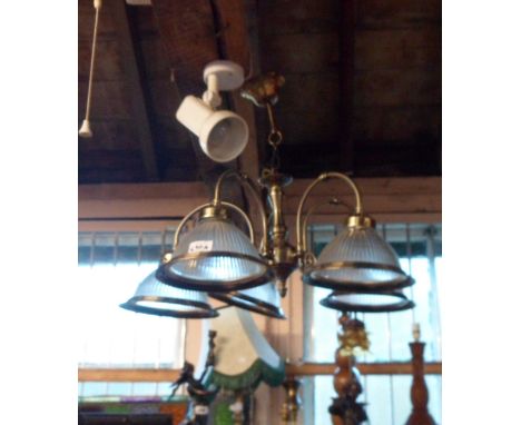 A modern five branch metal hanging ceiling light of armiture chandelier style with holophane type glass shades