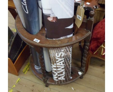 An early 20th Century oak freestanding bow front stick stand with barley twist supports and metal drip tray