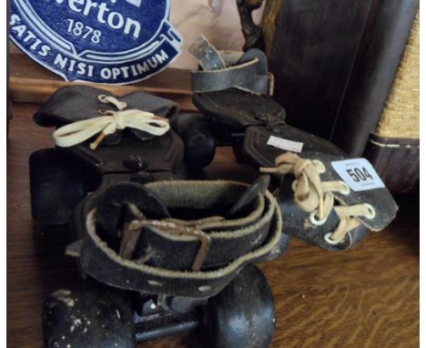 A pair of vintage overshoe roller skates
