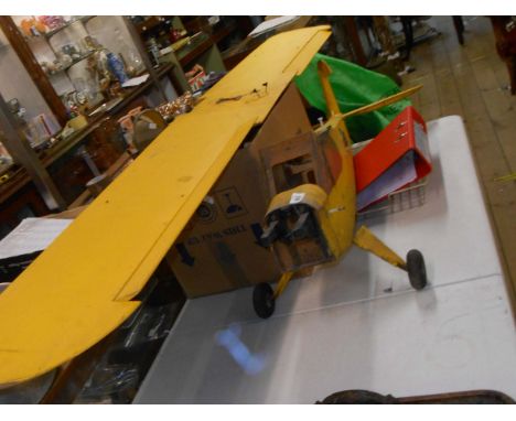 A large yellow remote control model plane carcass - no engine or propeller