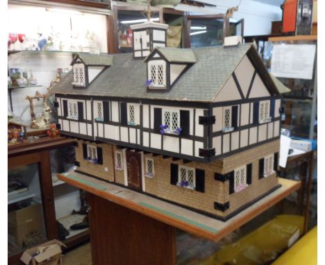 A large scratch built mock Tudor style nine bedroom doll's house with central clocktower and weather vane - Nat Stewart, Lost