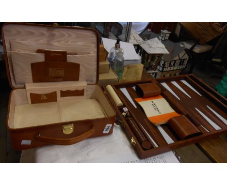 A cased backgammon set with instruction booklet and playing pieces - sold with a vintage leather writing case