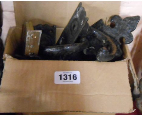 A box containing a quantity of door furniture including brass door knocker, iron letter box, handles, etc.