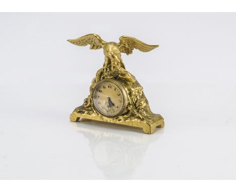 A small late 19th century French gilt clock, with eagle and snake on craggy base and inset watch style movement, with leather