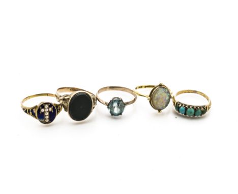 Five yellow metal gem set dress rings, comprising a 19th Century gold and enamel seed pearl set posy ring, the oval setting s