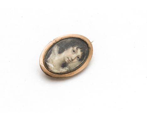 An 18th Century oval gold framed miniature brooch, the glazed panel with painting of a three quarter length portrait of a you
