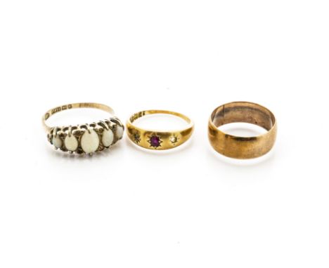 Three gold rings, including a ruby and diamond 18ct gold three stone gypsy set example, ring size L (worn), a 9ct gold weddin