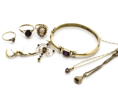 An amethyst set 14ct gold bangle, an art nouveau drop pendant, three gem set rings and various gold chains, 33g 