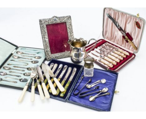 A collection of silver and silver plate, including a silver photograph frame, a silver caped cut glass scent bottle, and a la