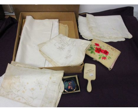 A small selection of vintage bedding, a mirror, compact and stocking case.