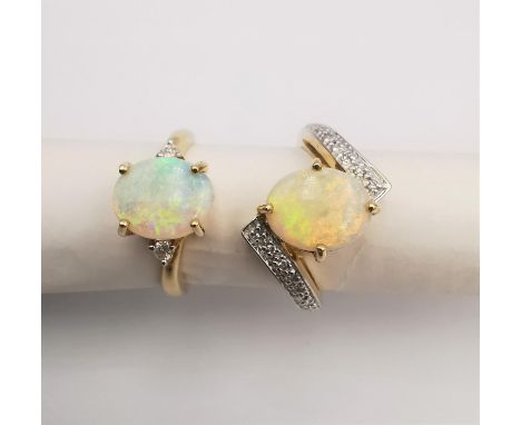 Two 14ct opal and diamond rings, one twist design with diamond accents and the other a flanked solitaire. Both stamped 14K. 