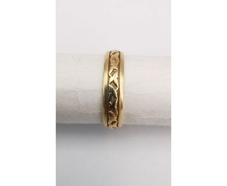 A 14 carat yellow gold engraved wedding band. Stamped 14K with engraved inscription.  Ring size K. Weight 2.5g. 