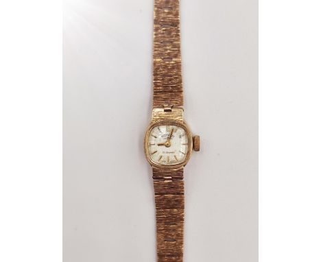 A ladies 1970's 9ct gold Rotary automatic cocktail watch. It has an articulated bark textured bracelet with adjustable clip c