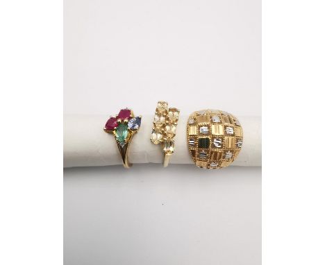 Three 20th century 9 carat gold gem-set rings, a rose and white gold checkerboard dress ring (2.34g), a topaz  dress ring and